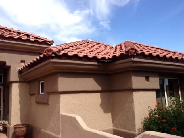 house with trimmed branches by stormproof roof