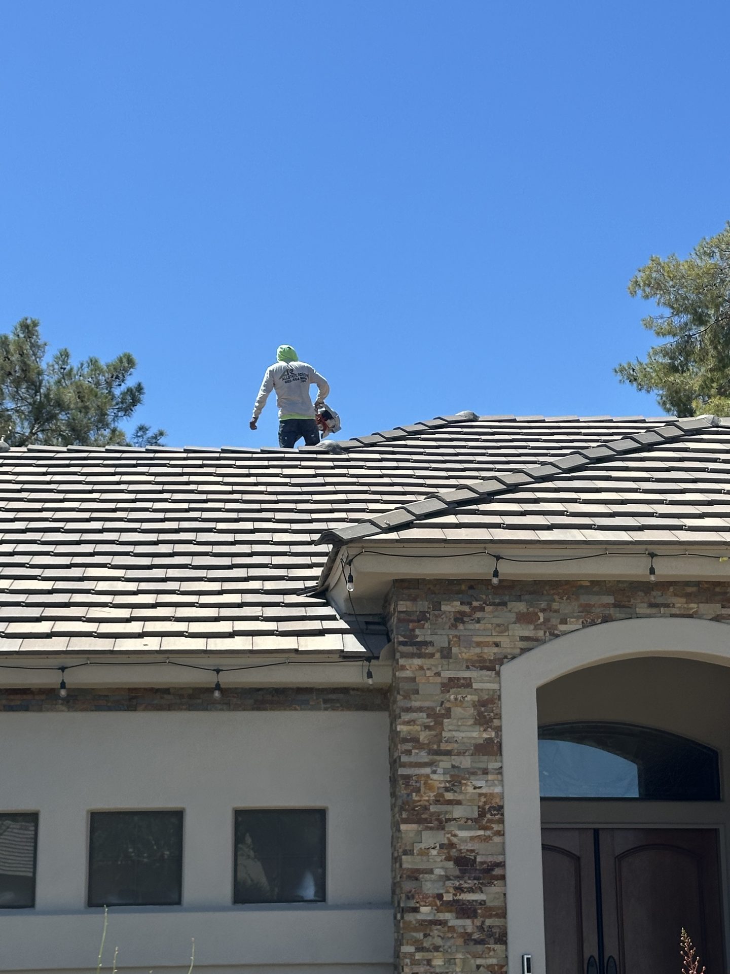 Allstate Roofing tech on a concrete tile roof