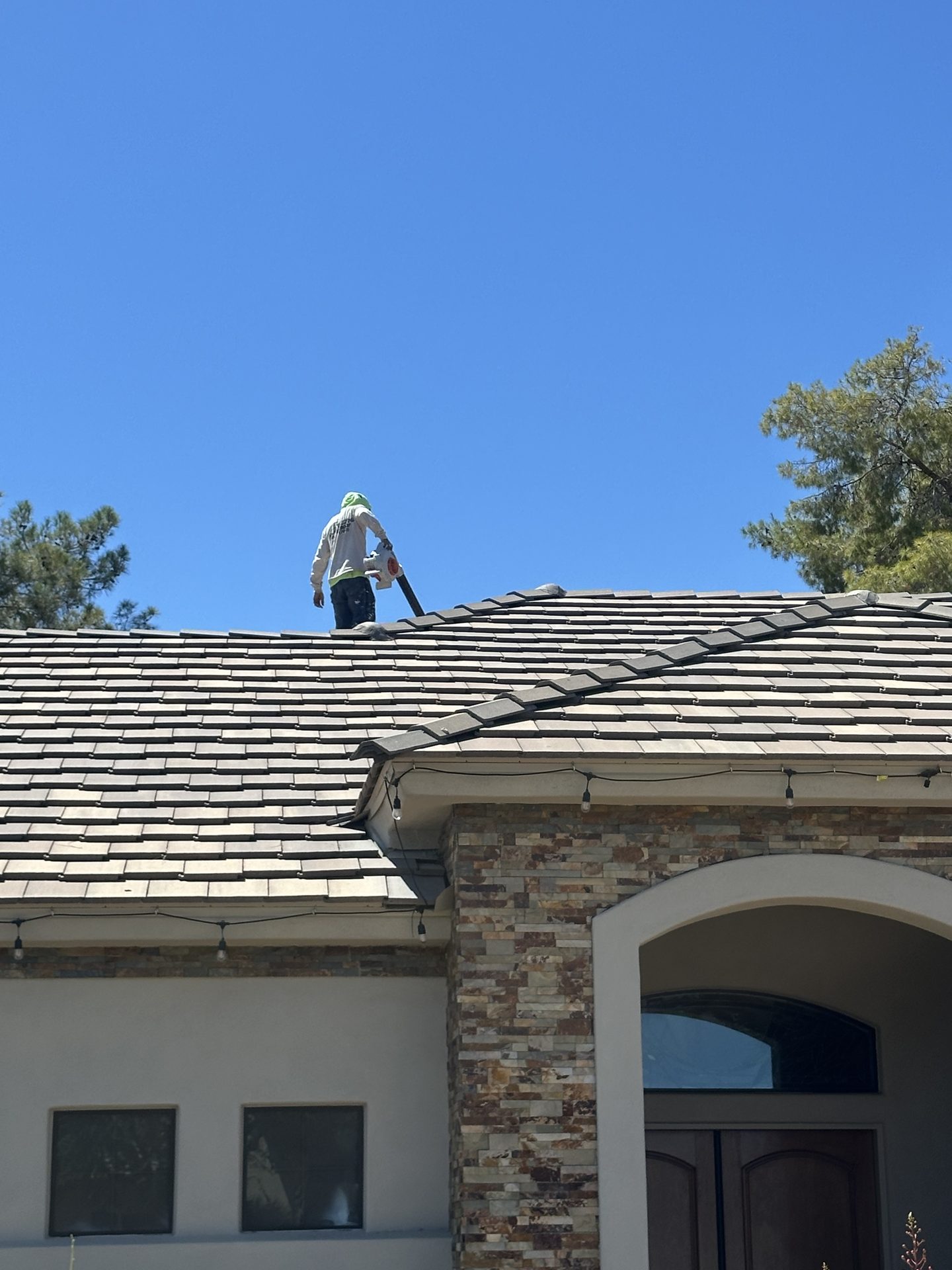 Roofer servicing a concrete tile roof in Arizona